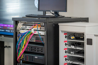 Photo of a server rack with a monitor on it.
