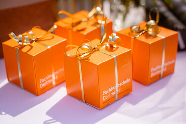 Gifts for the graduates wrapped in orange cubes