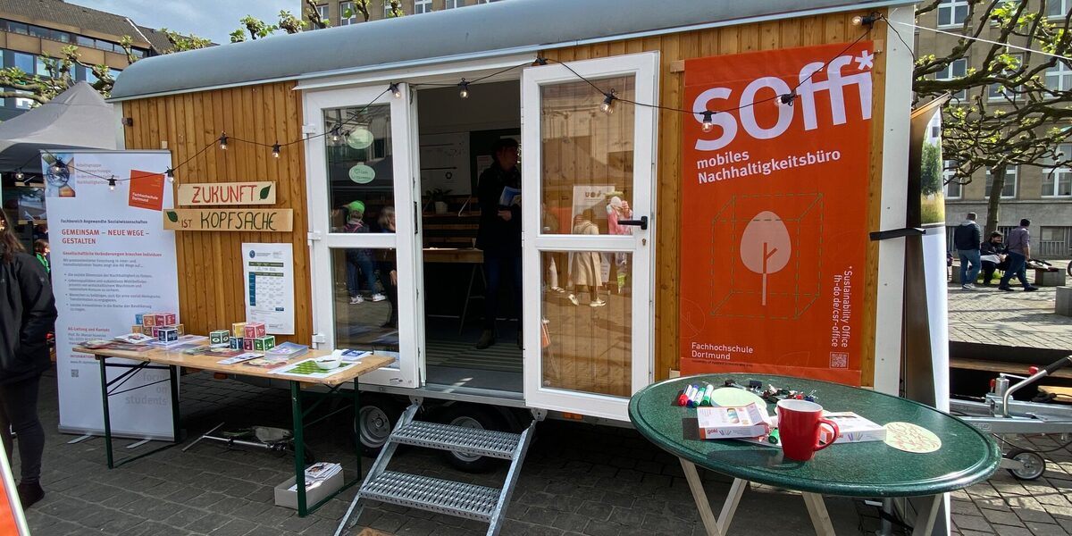 A converted construction trailer, which now serves as a mobile sustainability office, stands in a square for the exhibition.