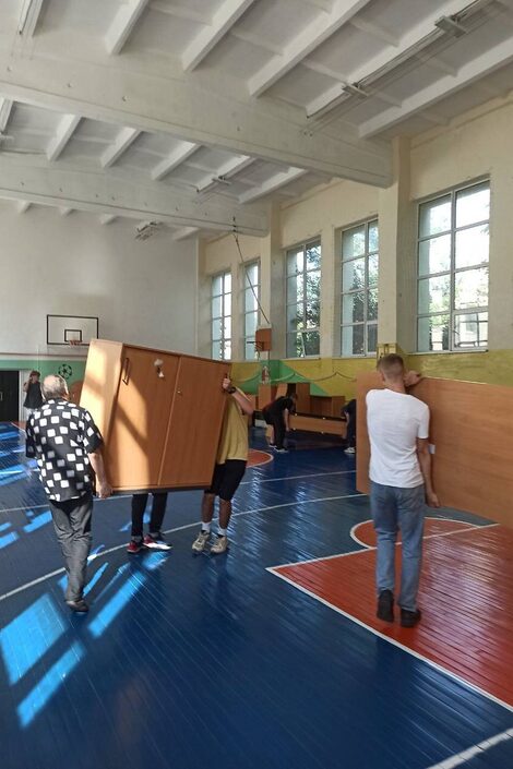 Furniture is unloaded by helpers in Ukraine