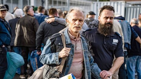 A man is taken out of prison by a court employee